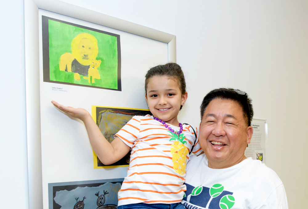 child artist with father and her art