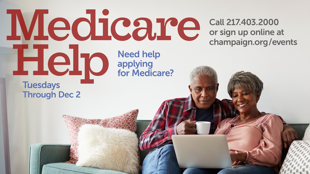 A senior couple relaxing on their couch with coffee looking at a laptop computer